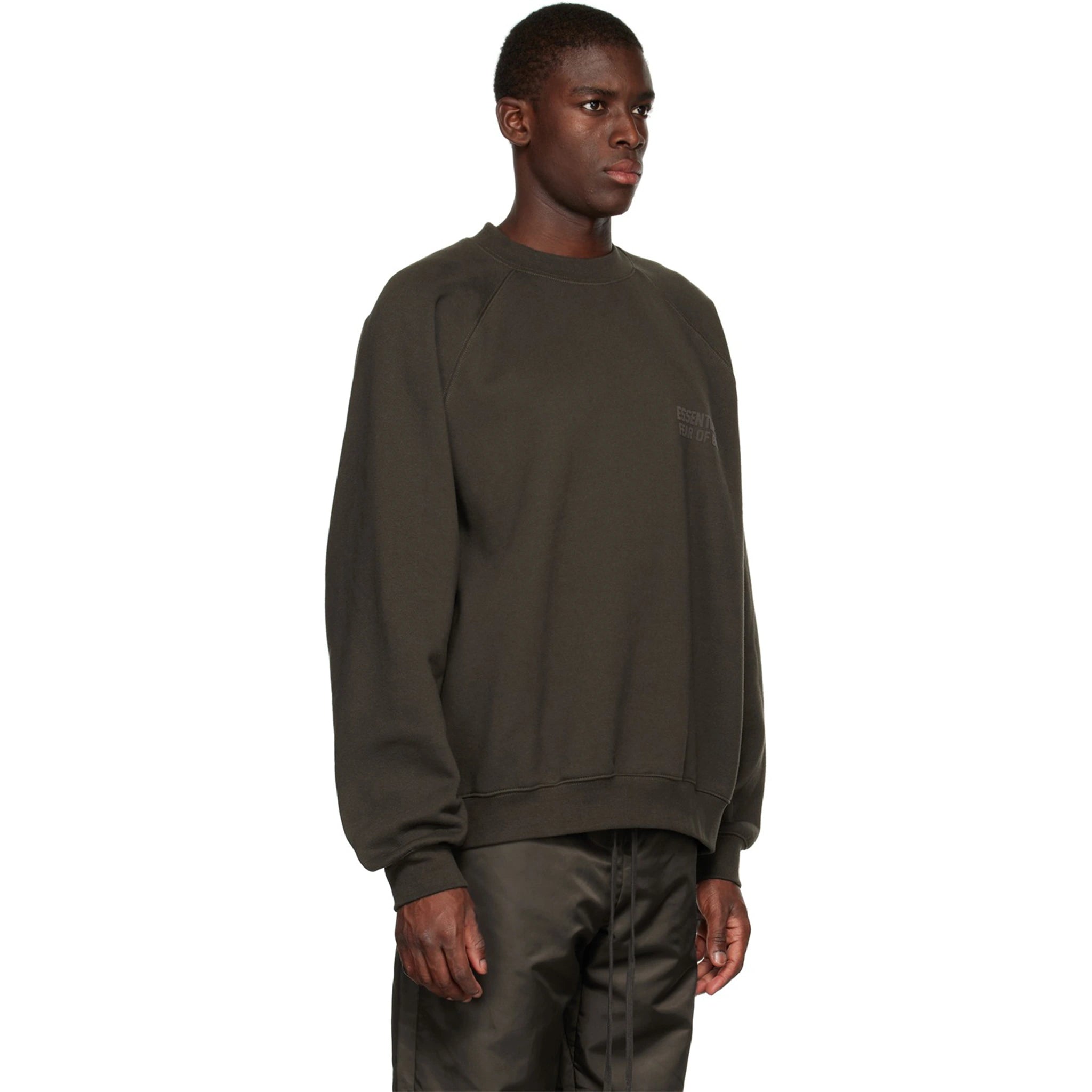 Model side view of Fear Of God Essentials Off Black Sweatshirt (SS23) 192BT222040F